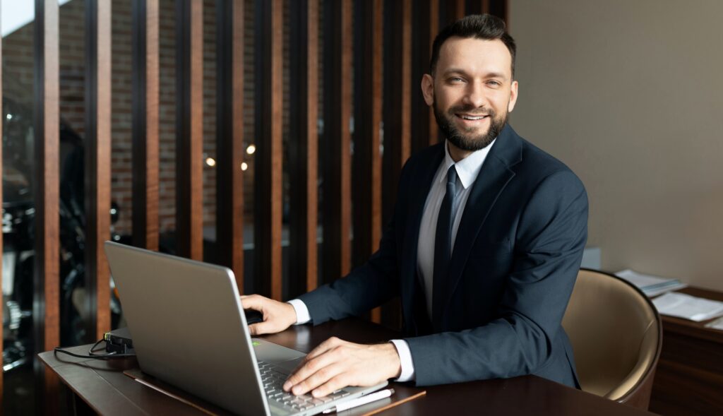 polite bank worker working on a laptop in a stylish office